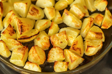Delicious baked potatoes on glass plate, closeup