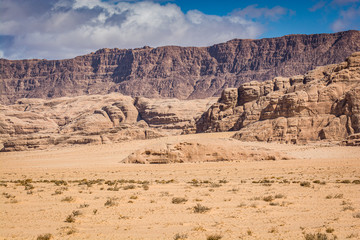 Desert with sandstone and granite rock in shape of boat in Wadi Rum in Jordan