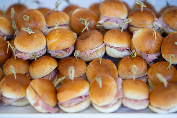 Small buttered sandwiches with ham and cheese