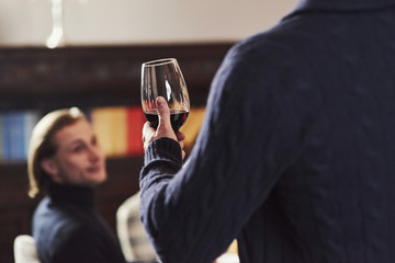 Attention to the guy who's making toast in the restaurant for his friends