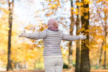 people and season concept - happy woman enjoying beautiful autumn outdoors
