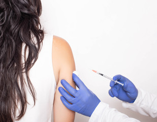 Allergist doctor injects against allergies to a young girl, a medical. Allergen-specific...