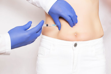 Doctor cosmetologist makes Botox injections and rejuvenation in the stomach of a girl. Smoothing...