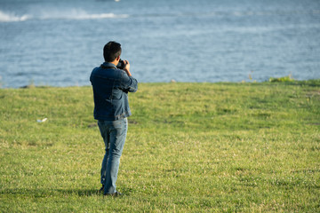 unknown photographer takes a break to review his image