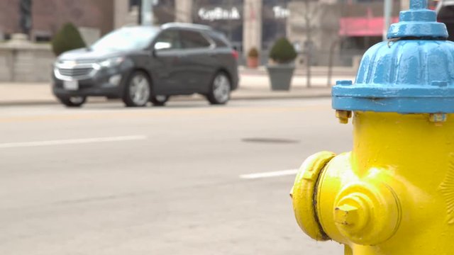 Fire Hydrant in downtown city slow motion cars go by