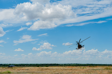 Fototapeta na wymiar Flying military transport helicopter special for army soldier in fight war. Military soldier volant in transport helicopter above clean blue sky. Helicopter is military transport to army soldier
