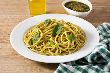 Spaghetti pasta with pesto sauce on wooden table