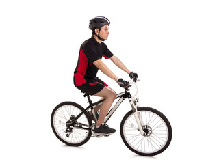 Naklejka premium Sideways profile of a guy riding a mountain bike, full length shot over white background