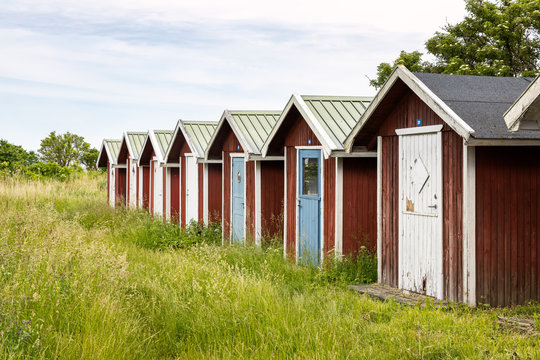 Fishing sheds among wild grasses in Kivik, Sweden.