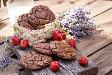 chocolate chip cookies with fresh ripe strawberries on wooden background