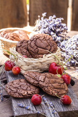 chocolate chip cookies with fresh ripe strawberries on wooden background