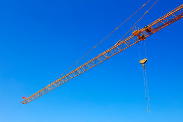 Tower crane arm in the blue sky background