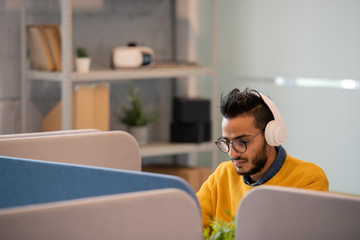Arabian office worker in headphones