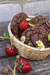chocolate chip cookies with fresh ripe strawberries on wooden background