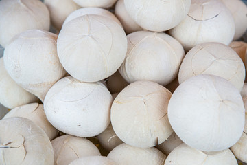 Burnt coconut in the market. Fresh coconuts in the market. Many coconut are stacked. line up of burned coconuts at traditional market.