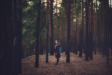 Fototapeta premium Pretty happy woman posing in forest and looking at camera.