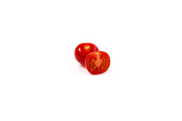 two red cherry tomatoes one in a cut