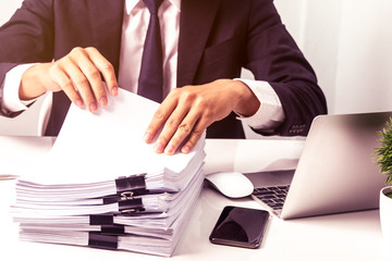 Businessmen are searching for documents lying on the table,business report papers,important documents.