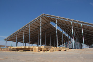 Construction of agricultural facilities. Wooden beams for the construction of the roof against the...