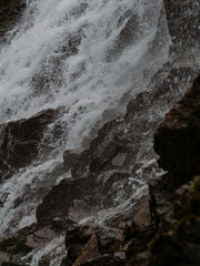 Fototapeta premium Stormy waters of the northern waterfall in a rocky gorge on the shores of the cold sea