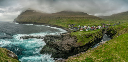 Natural harbour gorge in Gjogv village, Faroe Islands