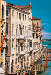 Fototapeta na wymiar Narrow channel between colorful historic houses in Venice, Italy