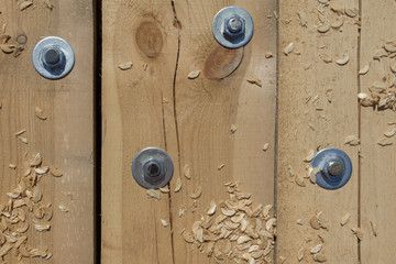 Background of wooden beams fixed between each other by large bolts