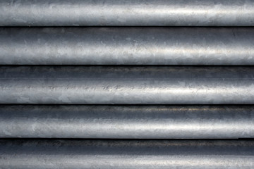 Background metal, coated with zinc. Zinc pipe coating to protect metal from corrosion.