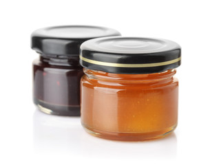 Small glass jars of apricot and blueberry jam