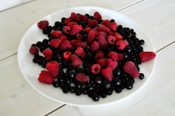 Frozen berries on a white wooden table