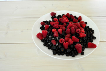 Frozen berries on a white wooden table