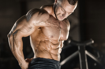 Fototapeta na wymiar muscular bodybuilder fitness men doing abs exercises in gym