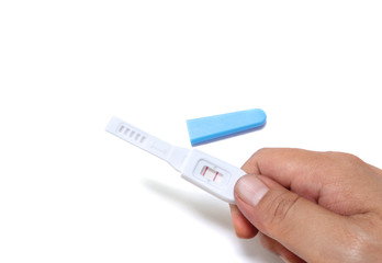 Obraz premium Closeup pregnancy examination equipment give positive result on hand isolated on white background