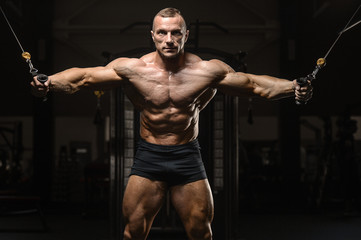 Fototapeta na wymiar muscular bodybuilder fitness men doing arms exercises in gym