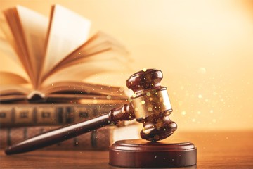Books and wooden gavel on table. Justice concept