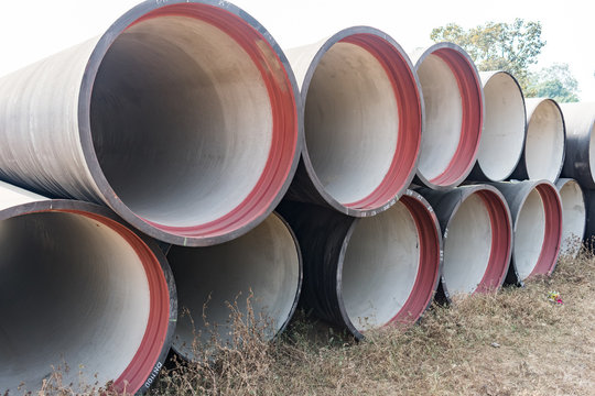 side view of ductile iron pipes stored in open space store yard.