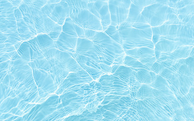 bright ripple surface of light blue swimming pool with sun reflect view from top see through floor...
