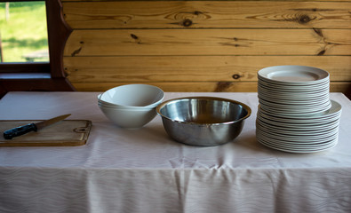 a stack of bowls on a table with a white tablecloth