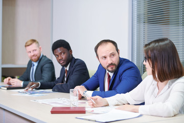 Confident businessman consulting with his young female colleague