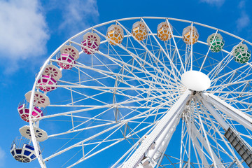 Ferris Mill, big  wheel on a background of blue sky.