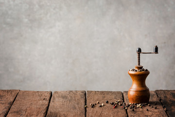 Retro pepper mill on wooden table