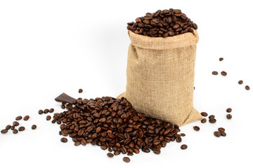 Coffee beans. Jute burlack sack with roasted coffee beans and coffee spatula, isolated on white background.