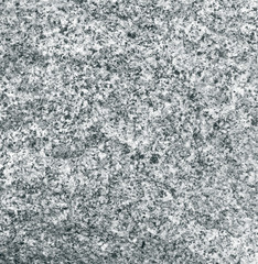 Granular texture of granite closeup. Rough stone surface.