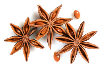 Star anise. Three star anise fruits with two seeds. Macro close up Isolated on white background with shadow, top view of chinese badiane spice or Illicium verum.
