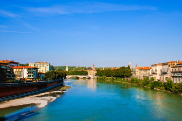 Fototapeta na wymiar Verona, Italy: Panoramic view of the Adige river from the bridge Ponte Scaligero.
