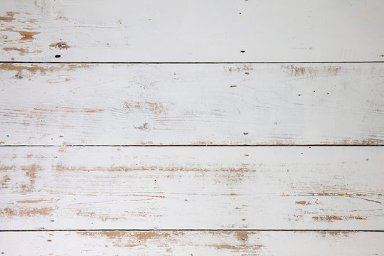 White wooden floorboards. Distressed worn floorboard background painted white