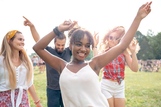 Friends dancing and having fun at summer music festival