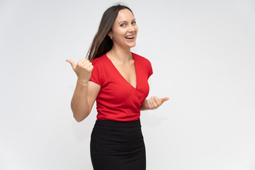 Portrait to the waist of a young pretty brunette woman of 30 years old in a bright red sweater with...