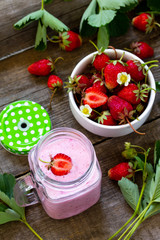 Dietary breakfast for summer time, vegan food concept. Fresh Strawberry milkshake on rustic wooden table.