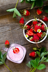 Dietary breakfast for summer time, vegan food concept. Fresh Strawberry milkshake on rustic wooden table. Free space for your text. Top view flat lay background.